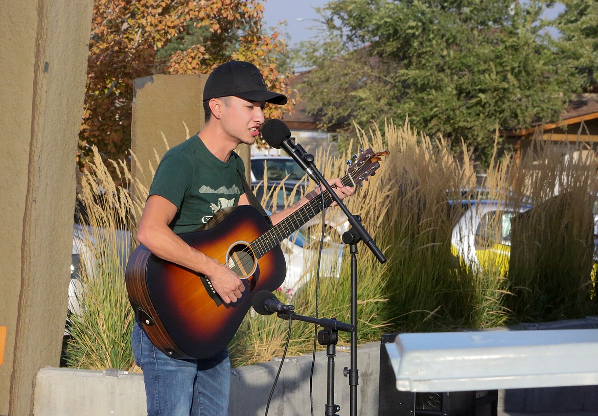 Nick Garcia performed a pair of songs while playing acoustic guitar on stage in Sinkiuse Square at the Downtown Open Mic Night event in Moses Lake on Thursday.