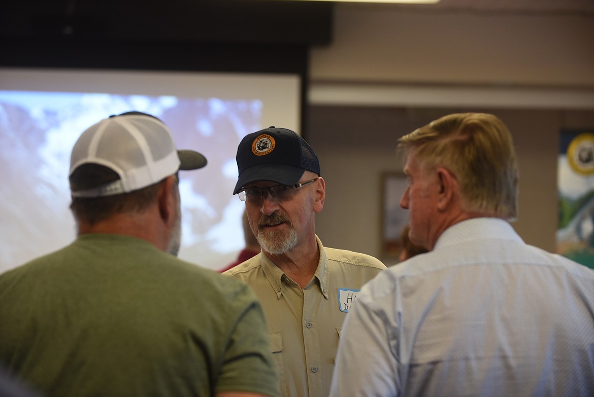 Montana Fish, Wildlife and Parks director Hank Worsech speaks to state Rep. Paul Fielder, right, and Marion resident Terry Zink at a meet and greet last week in Kalispell. (Scott Shindledecker/Daily Inter Lake)