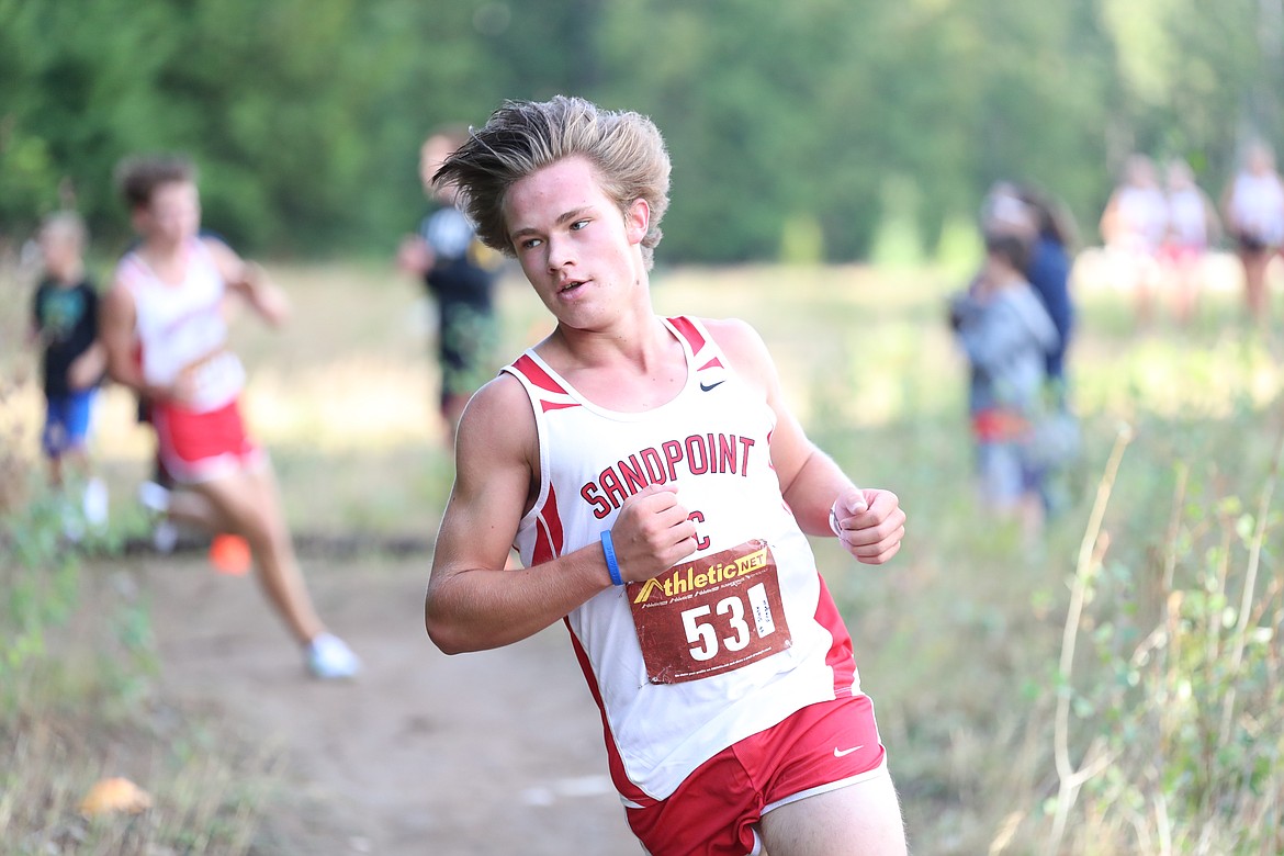 Junior Slate Fragoso rounds a corner during the Pine Street Woods Invite. He won the boys race at the dual with a time of 15:04.