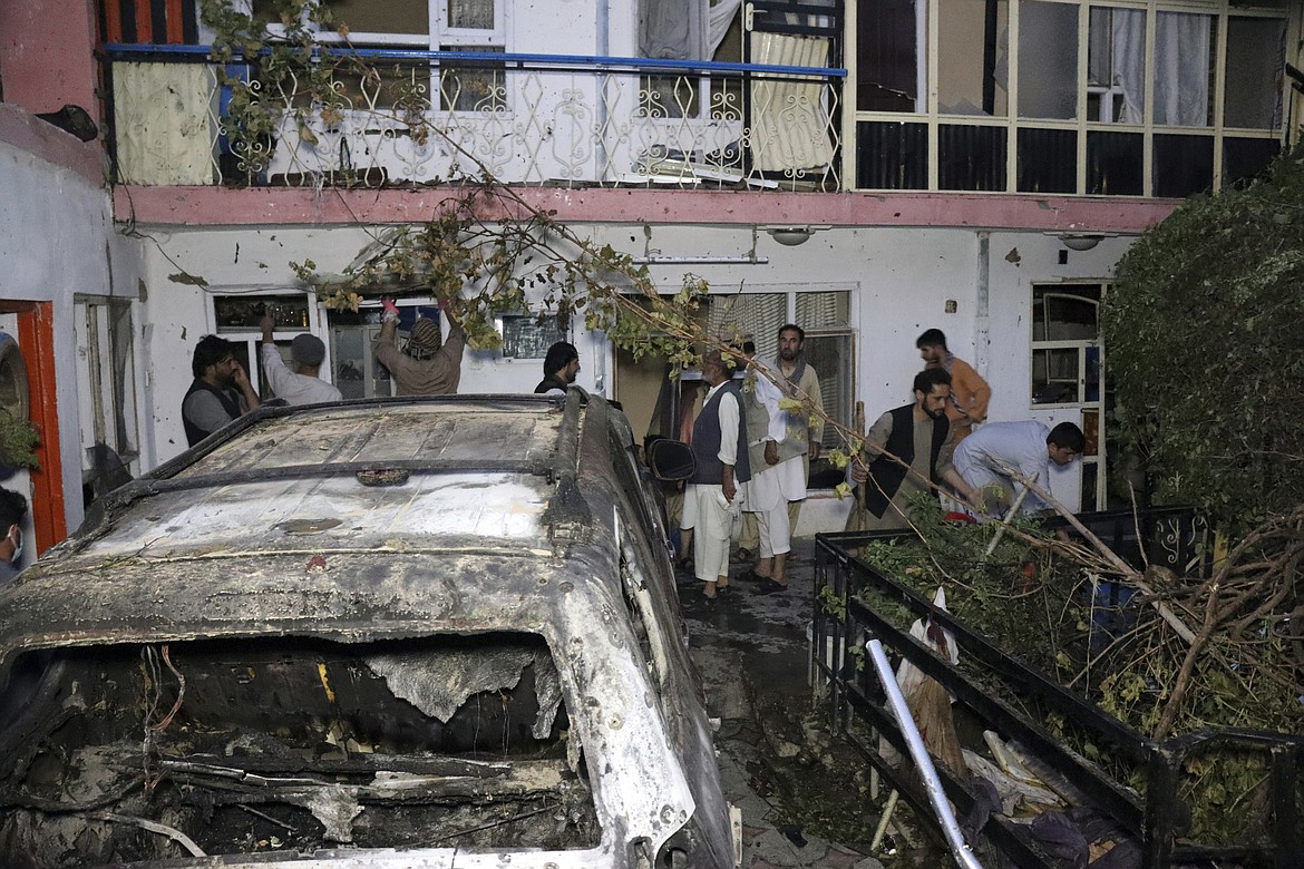 Afghan people are seen inside a house after a U.S. drone strike in Kabul, Afghanistan, on Sunday, Aug. 29, 2021. A U.S. drone strike destroyed a vehicle carrying "multiple suicide bombers" from Afghanistan's Islamic State affiliate on Sunday before they could attack the ongoing military evacuation at Kabul's international airport, American officials said. (Khwaja Tawfiq Sediqi/Associated Press)