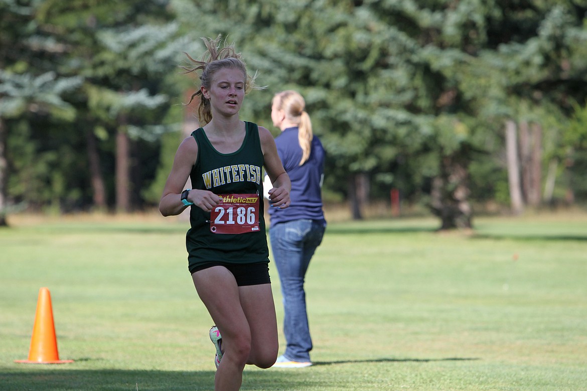 Whitefish's Morgan Grube runs to a fifth-place finish in the girls varsity 5,000 meters at the Libby Cross Country Invitational meet on Friday. (William Langhorne/The Western News)