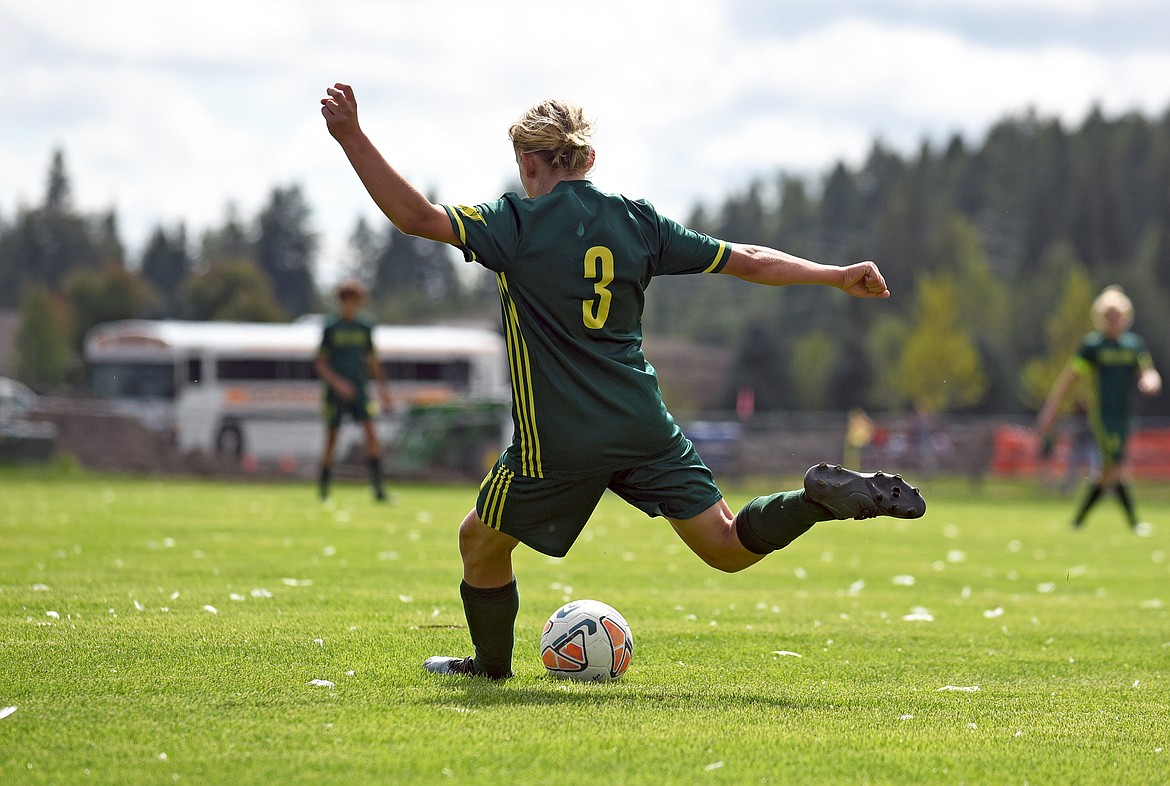 Bulldog Chase Sabin crosses the ball during a game against Frenchtown at Smith Fields in Whitefish on Saturday. (Whitney England/Whitefish Pilot)