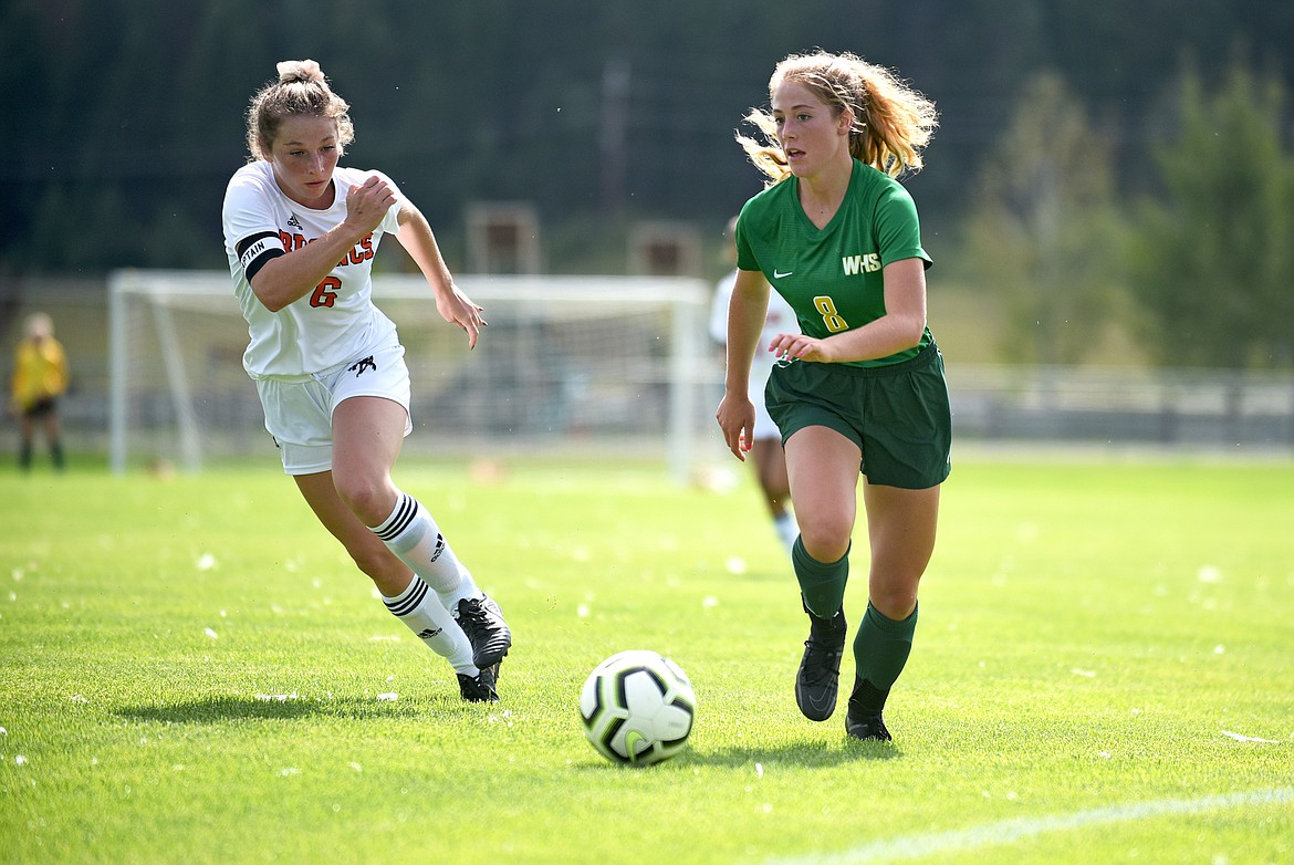 Lady Bulldog Brooke Roberts dribbles the ball down the sideline past a Frenchtown defender in a game at Smith Fields on Saturday. (Whitney England/Whitefish Pilot)