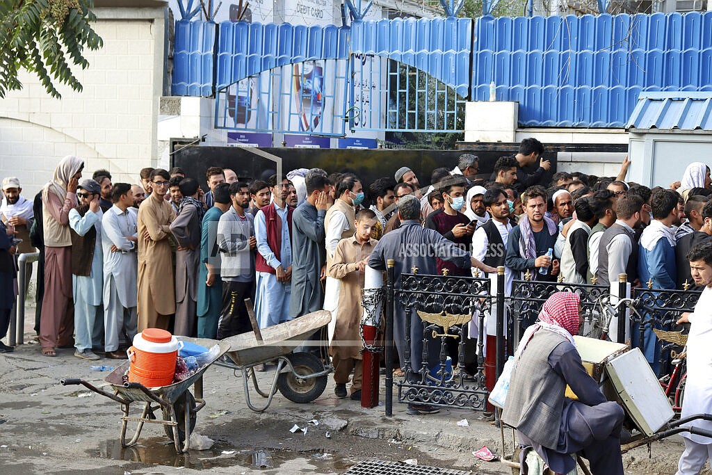 Afghans wait in long lines for hours to try to withdraw money, in front of a bank in Kabul, Afghanistan, Monday, Aug. 30, 2021. The Taliban have limited weekly withdrawals to $200. (AP Photo/Khwaja Tawfiq Sediqi)