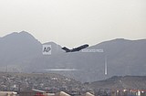 As US military leaves Kabul, many Americans, Afghans remain