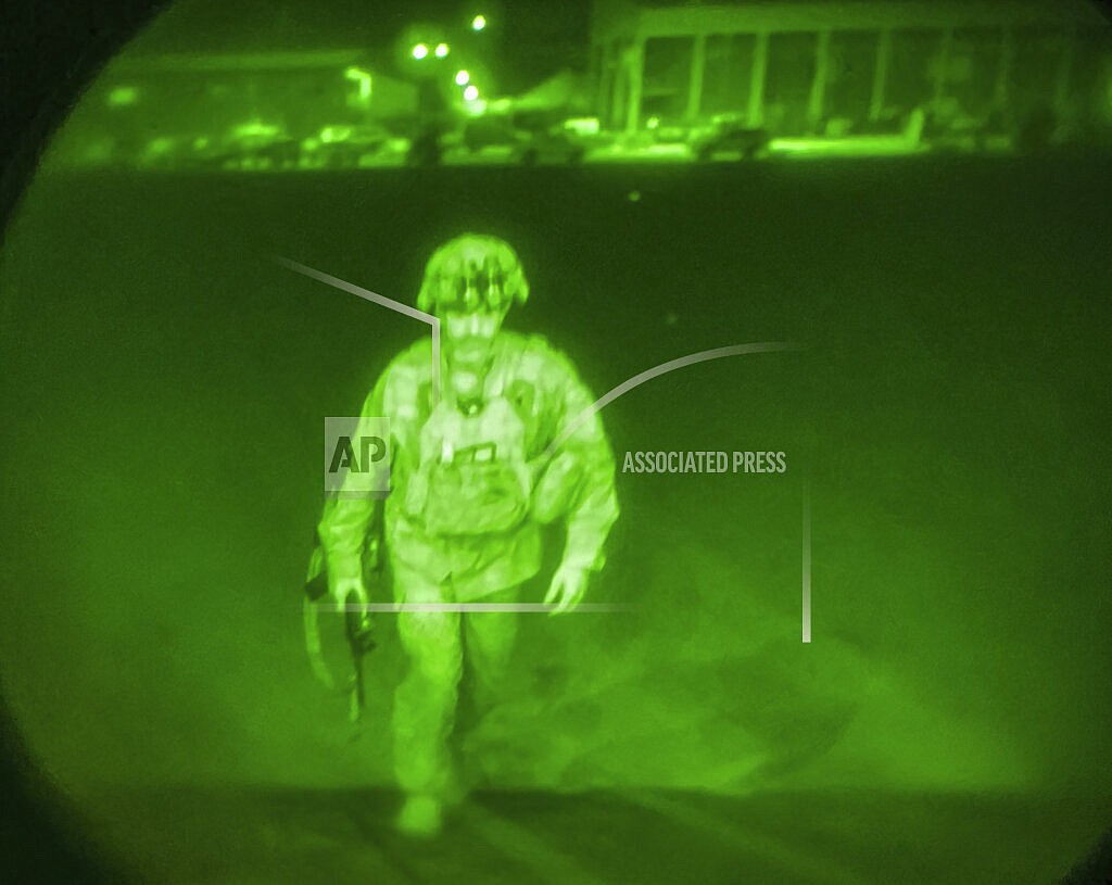 In this image made through a night vision scope and provided by U.S. Central Command, Maj. Gen. Chris Donahue, commander of the U.S. Army 82nd Airborne Division, XVIII Airborne Corps, boards a C-17 cargo plane at the Hamid Karzai International Airport in Kabul, Afghanistan, Monday, Aug. 30, 2021, as the final American service member to depart Afghanistan. (U.S. Central Command via AP)