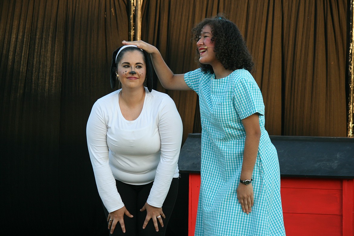 Snoopy (Marie Jamison, left) gets a pat on the head from Patty (Allie Manly, right) in the Quincy Valley Allied Arts’ production of “You’re a Good Man, Charlie Brown” Saturday.