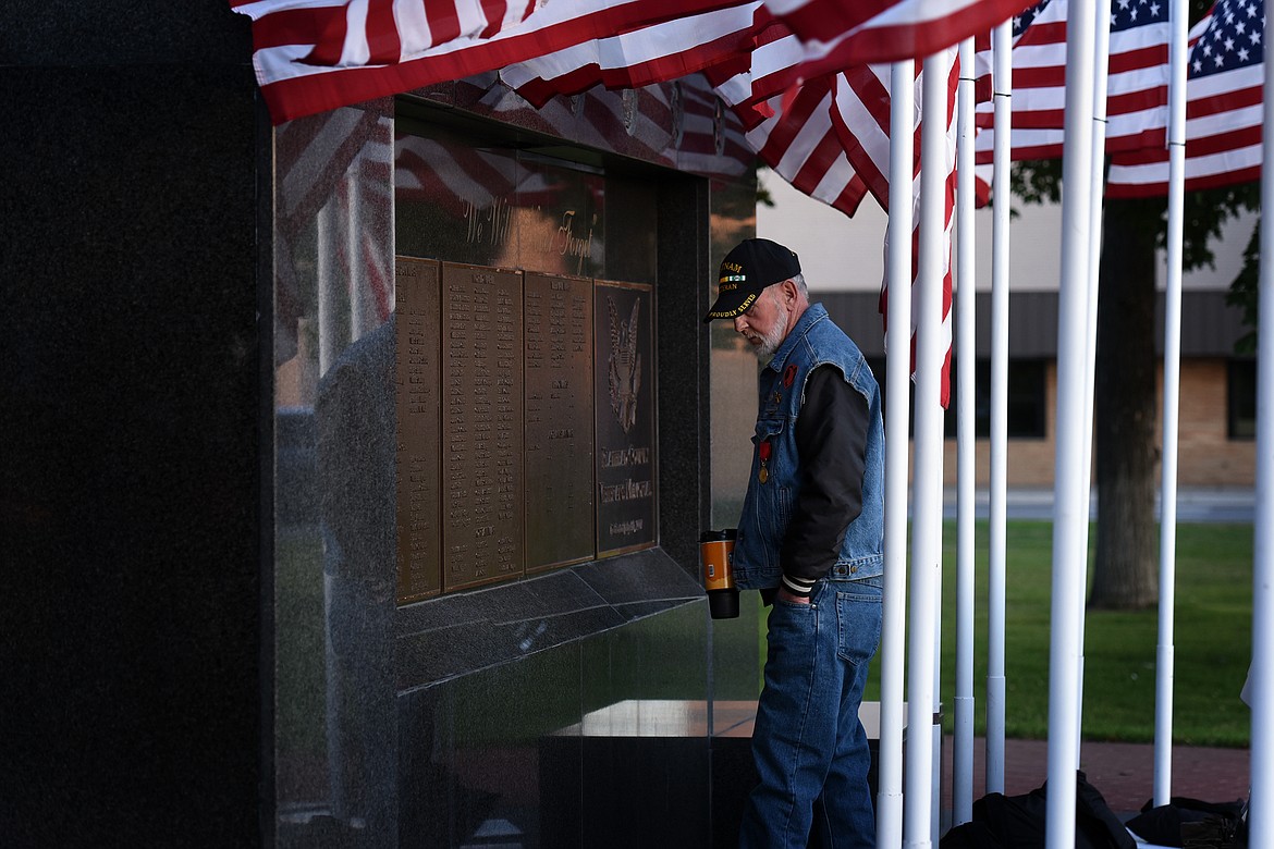 U.S. military veteran Clifford Nielsen looks over the names listed on the Flathead County Veterans Memorial in Kalispell's Depot Park on Tuesday, Aug. 31, 2021, shortly before a candlelight vigil was held to honor the 13 U.S. military personnel killed in an Aug. 26 attack outside the Kabul airport in Afghanistan. (Jeremy Weber/Daily Inter Lake)