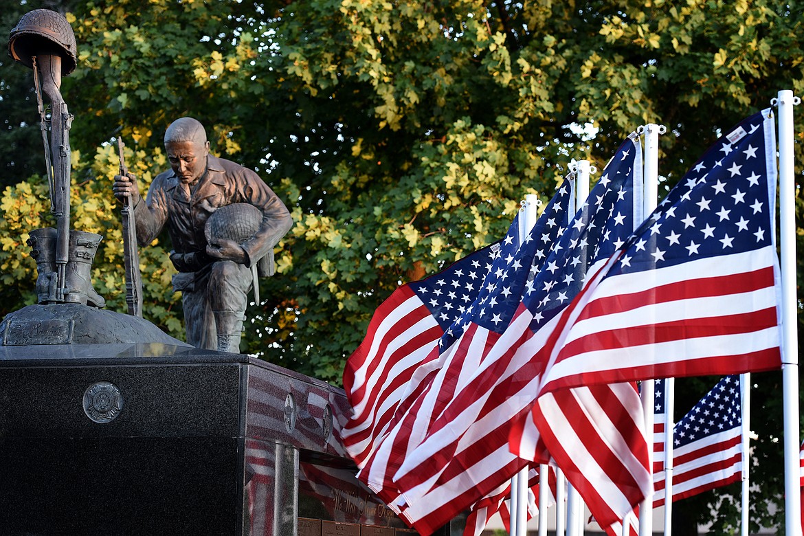 Flags adorn the Flathead County Veterans Memorial in Kalispell's Depot Park on Tuesday, Aug. 31, 2021, shortly before a candlelight vigil was held to honor the 13 U.S. military personnel killed in an Aug. 26 attack outside the Kabul airport in Afghanistan. (Jeremy Weber/Daily Inter Lake)