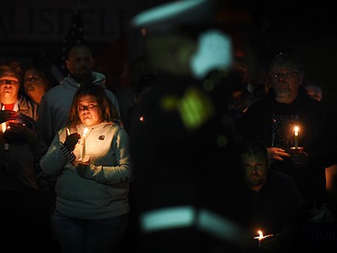 Kyrie Small looks on at the Flathead County Veterans Memorial in Kalispell's Depot Park on Tuesday, Aug. 31, 2021, as U.S. Marines pay respects during a candlelight vigil to honor the 13 U.S. military personnel killed in an Aug. 26 attack outside the Kabul airport in Afghanistan. (Jeremy Weber/Daily Inter Lake)
