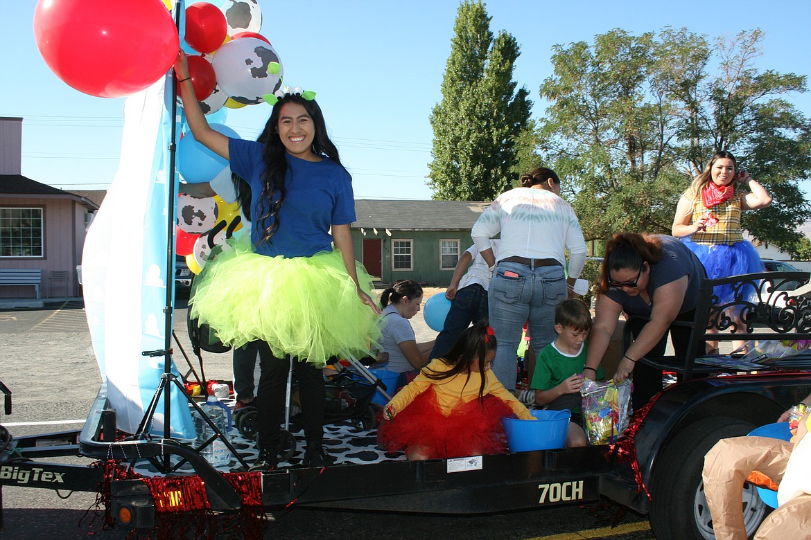 Participants wave and throw out candy during the Wahluke Community Day parade Saturday in Mattawa.