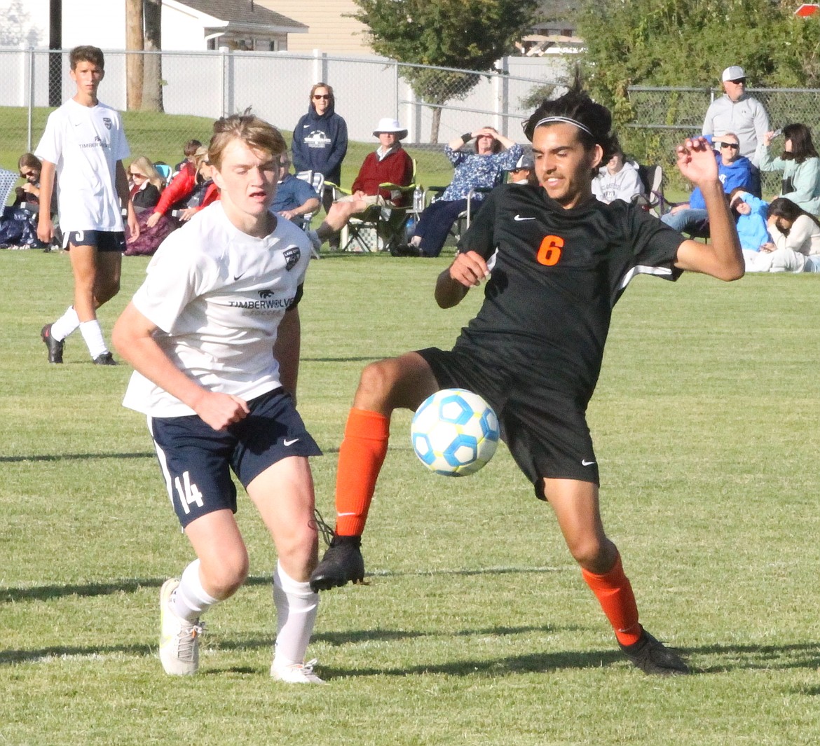 MARK NELKE/Press
Bryce Allred, left, of Lake City, and Jesus Aparicio (6) of Post Falls vie for the ball in the second half Tuesday at Post Falls High.