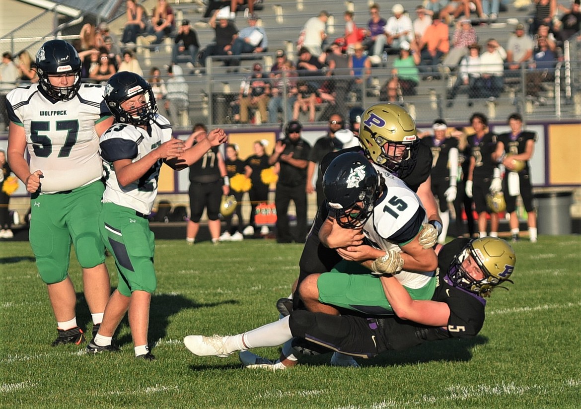 Trent Wilson (5) and Braunson Henricksen take down Glacier JV quarterback Isaak Keim. (Scot Heisel/Lake County Leader)