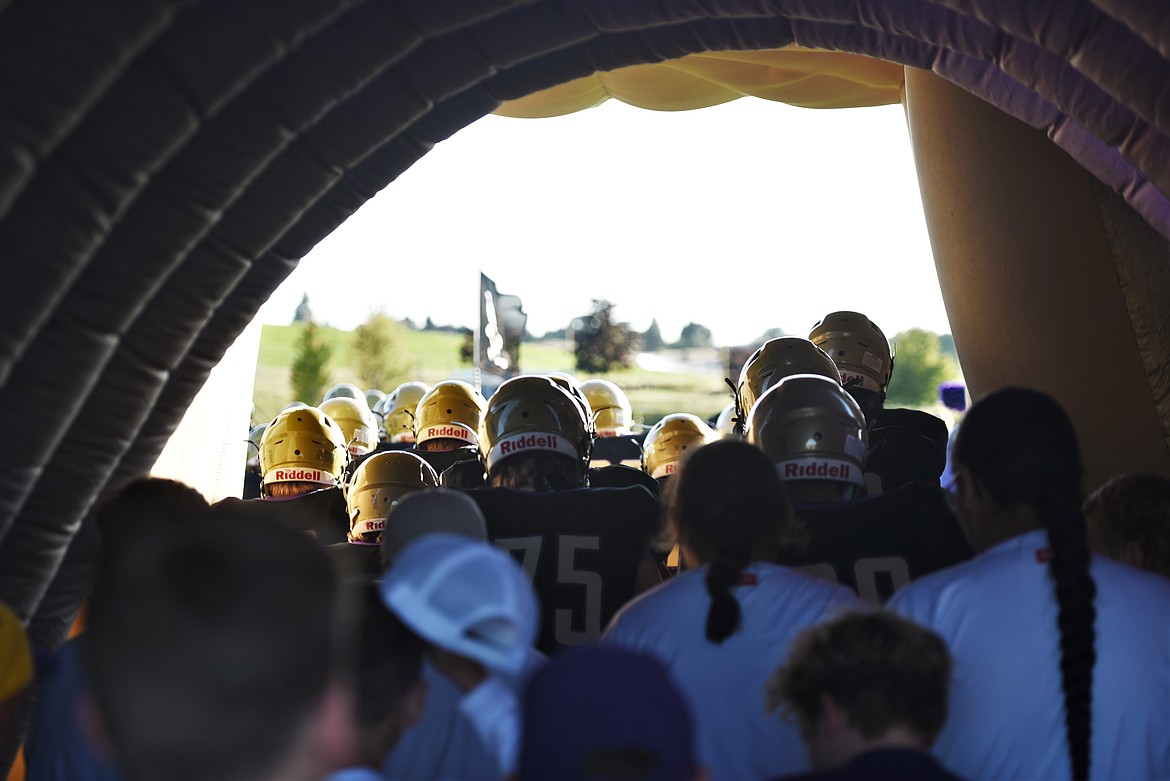 The Polson football team exits the tunnel to take the field at home for their season opener against Glacier's junior varsity squad. (Scot Heisel/Lake County Leader)