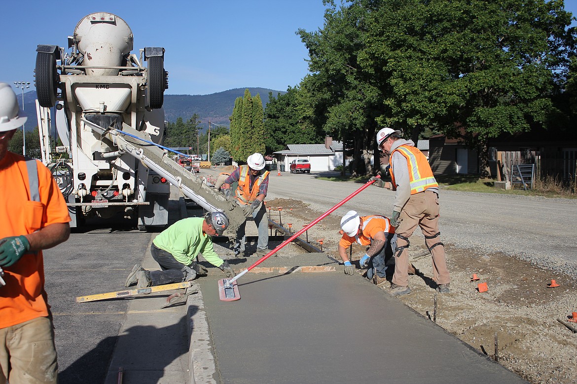 Workers pouring concrete for new sidewalk along Garden Lane (Photo by Rose Shababy)
