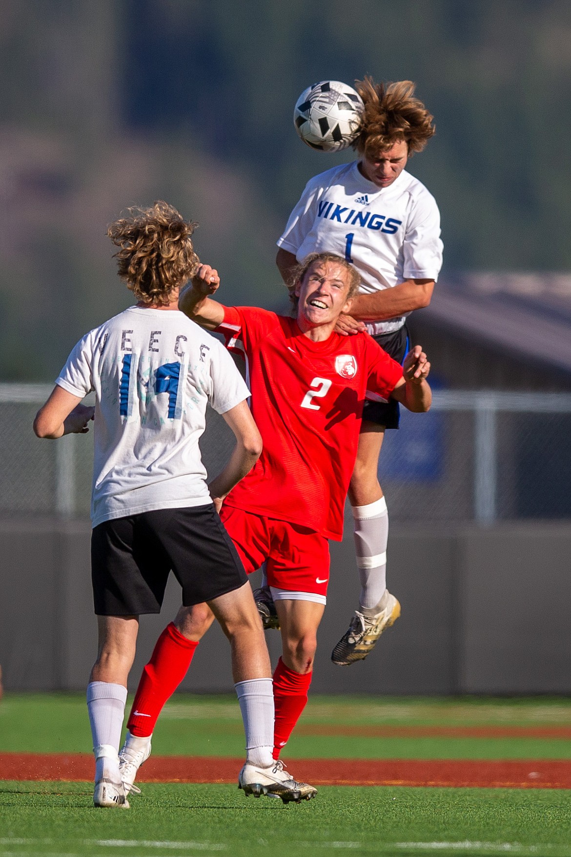 Jett Longanecker battles for position with a pair of Coeur d'Alene defenders on Thursday,