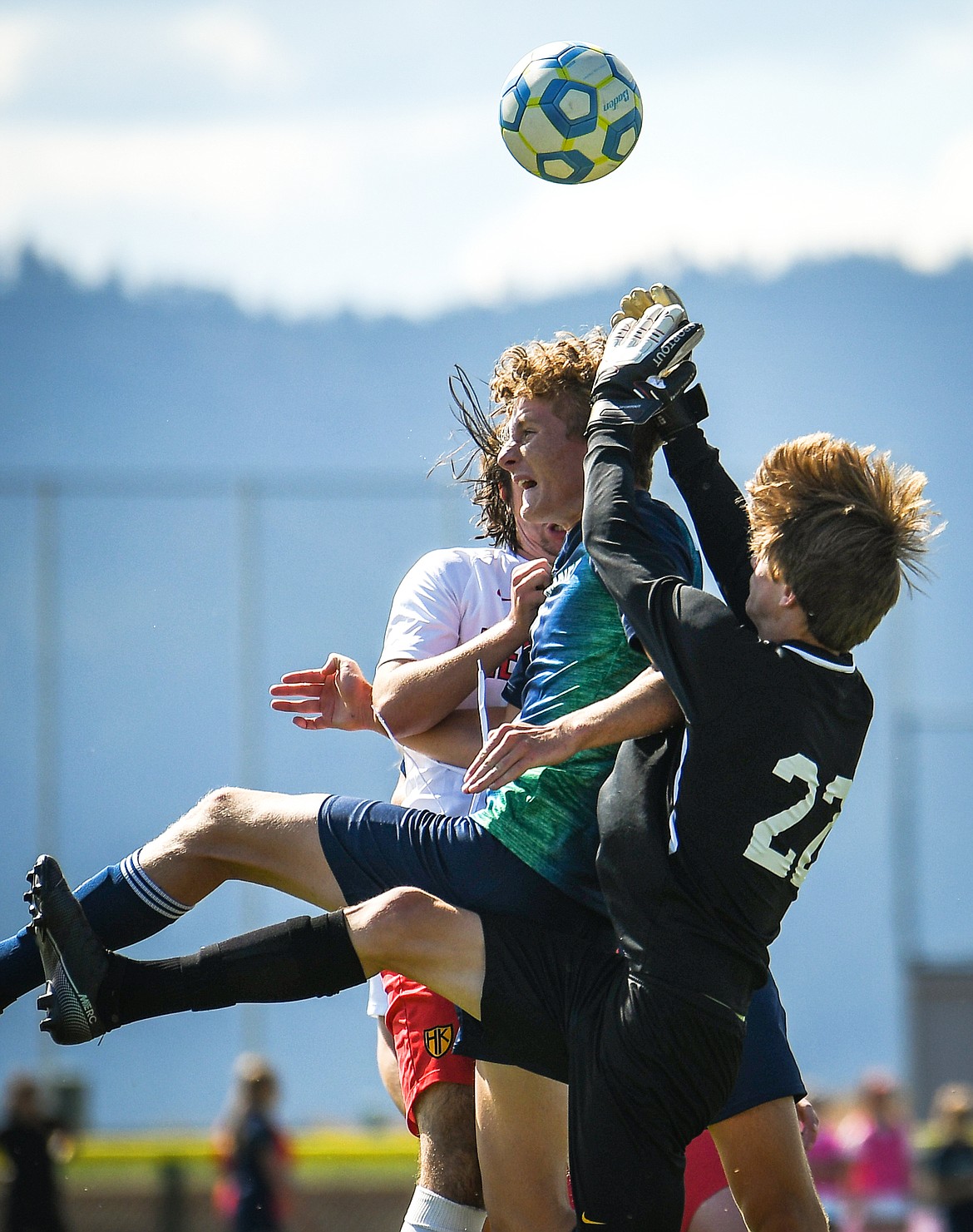 Glacier's Sullivan Coggins (7, center) and Missoula Hellgate goalkeeper Loren Deskins (22) collide while making a play on a ball in the first half at Glacier High School on Thursday, Sept. 2. (Casey Kreider/Daily Inter Lake)