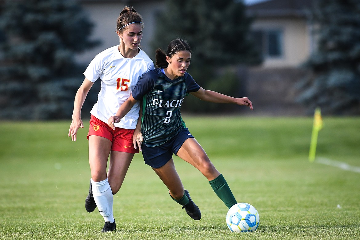 Glacier's Calista Wroble (2) pushes the ball upfield against Missoula Hellgate's Gabby Beaton (15) at Glacier High School on Thursday, Sept. 2. (Casey Kreider/Daily Inter Lake)