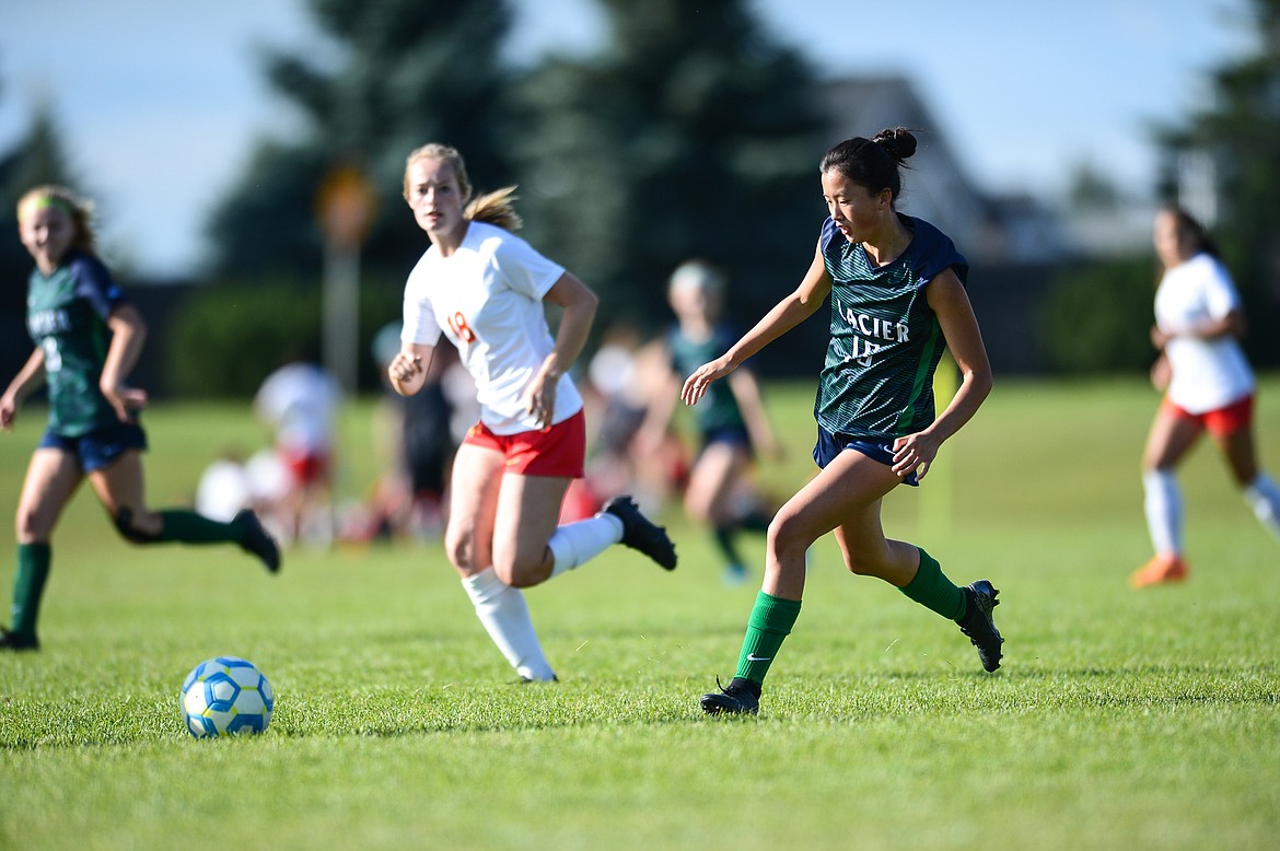 Glacier's Karys Camp (15) pushes the ball upfield against Missoula Hellgate at Glacier High School on Thursday, Sept. 2. (Casey Kreider/Daily Inter Lake)