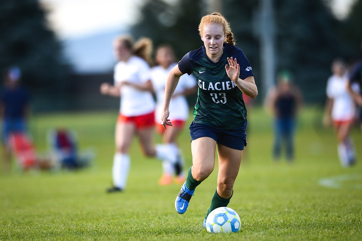 Glacier's Reese Ramey (23) pushes the ball upfield against Missoula Hellgate at Glacier High School on Thursday, Sept. 2. (Casey Kreider/Daily Inter Lake)