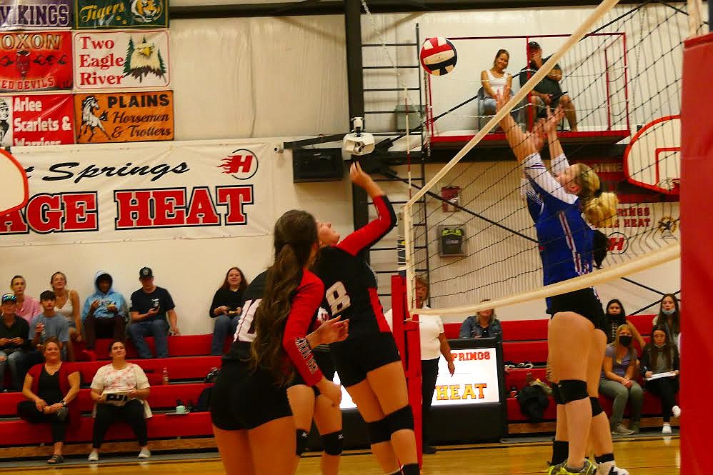 Volleyball players from Superior and Hot Springs battle at the net during last week’s match. (Chuck Bandel/Mineral Independent)