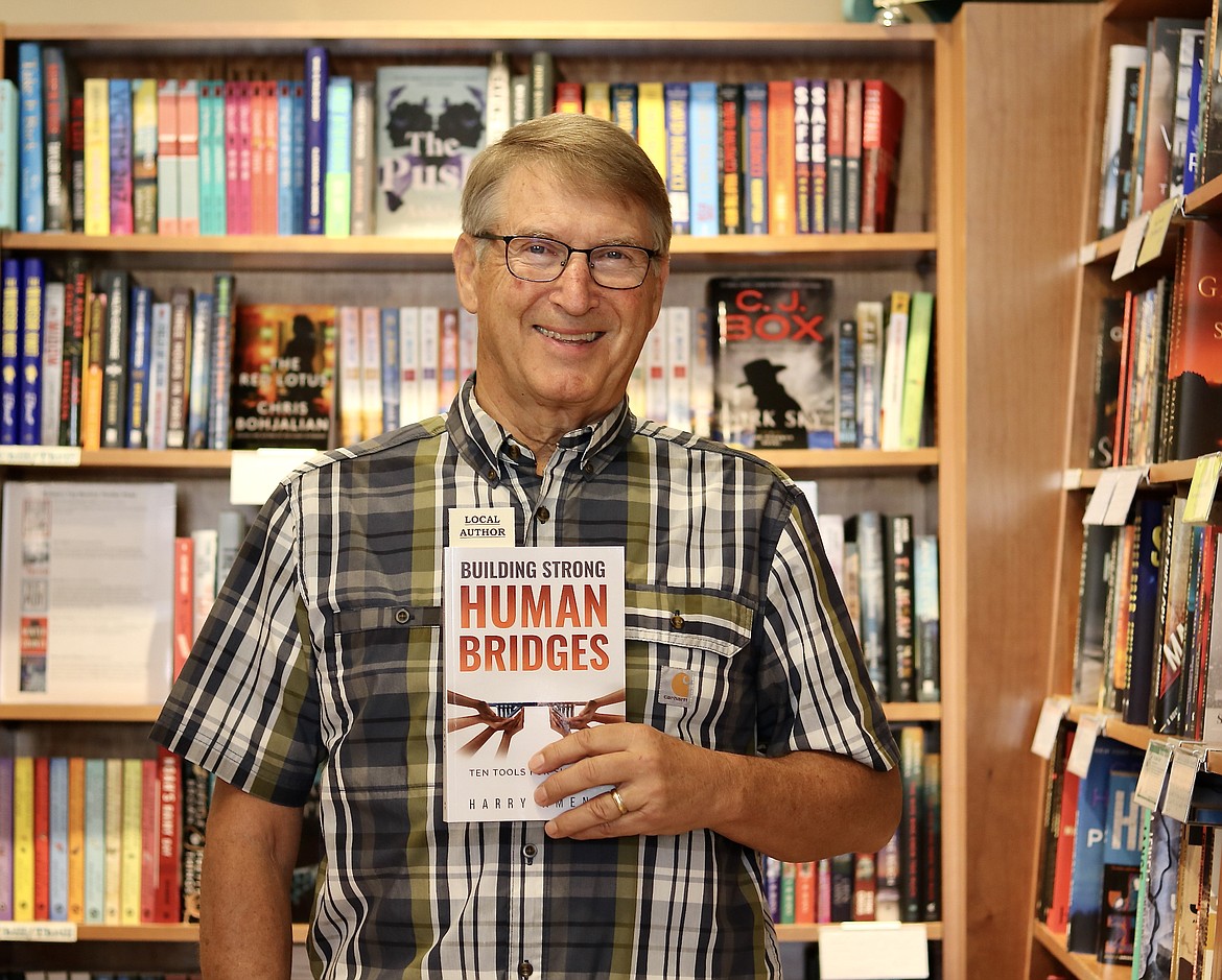 Harry Amend, a 41-year veteran in education and former superintendent of the Coeur d'Alene School District, holds his recently published book, "Building Strong Human Bridges: Ten Tools for Success," available the Well-Read Moose in The Village at Riverstone. HANNAH NEFF/Press