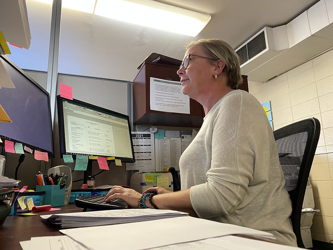 Elections Clerk 3 Christie Olesen plugs in the last candidate names as the filing period for November races pour in Friday evening. (MADISON HARDY/Press)