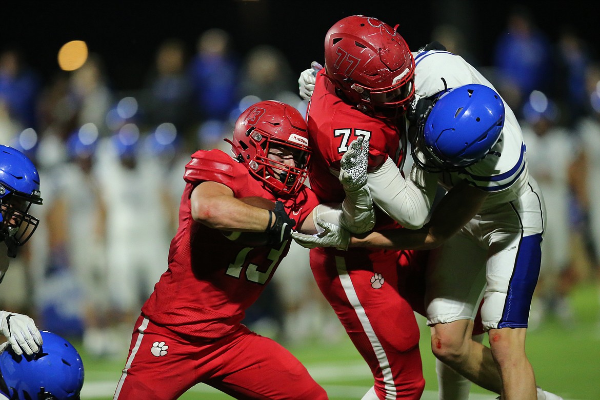 Gerrit Cox (left) runs through a hole created by a block from Wylan Dorrel on Friday.