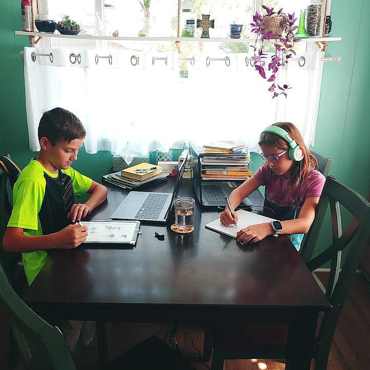 At their sunny kitchen table, Asher and Clara, work on their school work. It may not be a traditional classroom but more and more families across the state are finding that learning from home can have positive attributes. (Photo courtesy Becky Palmer)