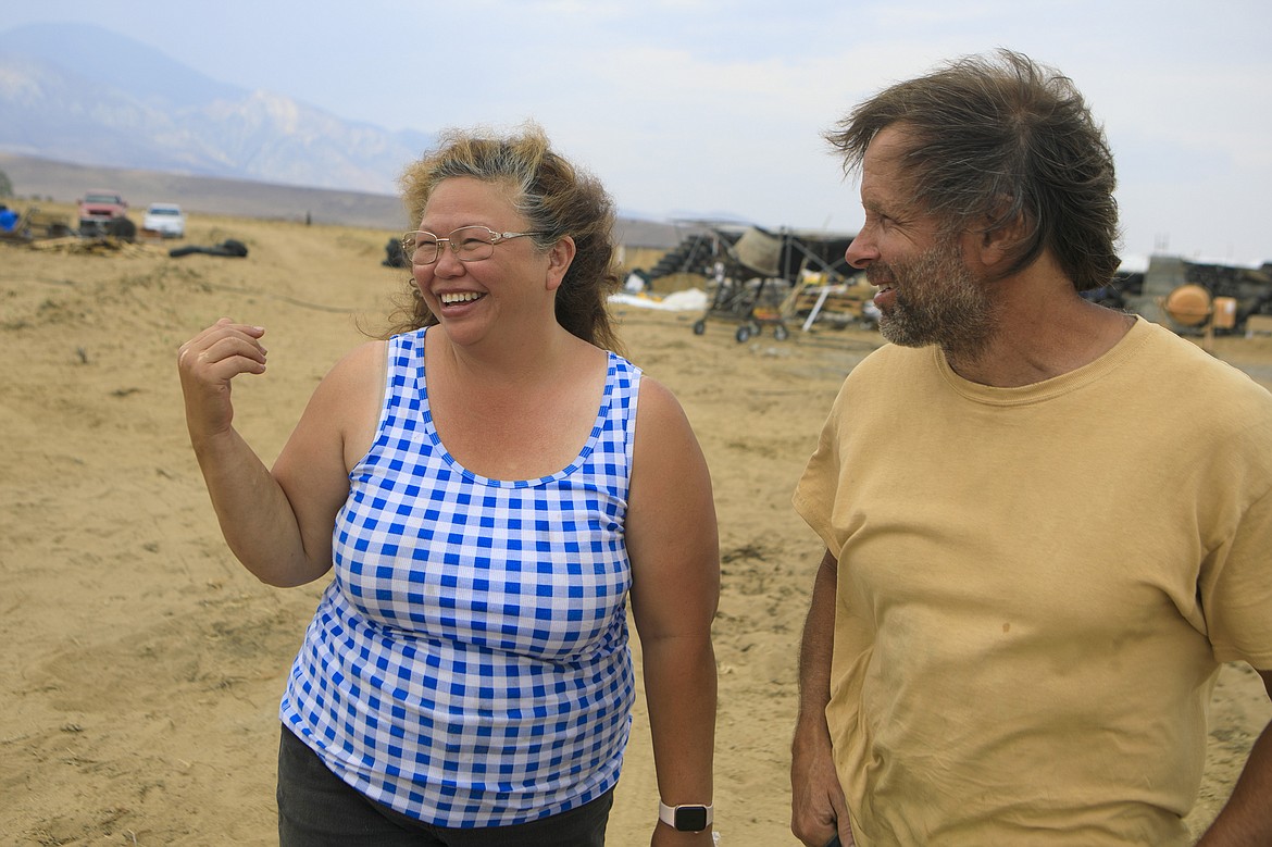 Ruth and Bill Craven walk around their property where they are building a type of home known as an Earthship, on Thursday July 29, 2021, near Belfry, Mont. (Ryan Berry/Billings Gazette via AP)