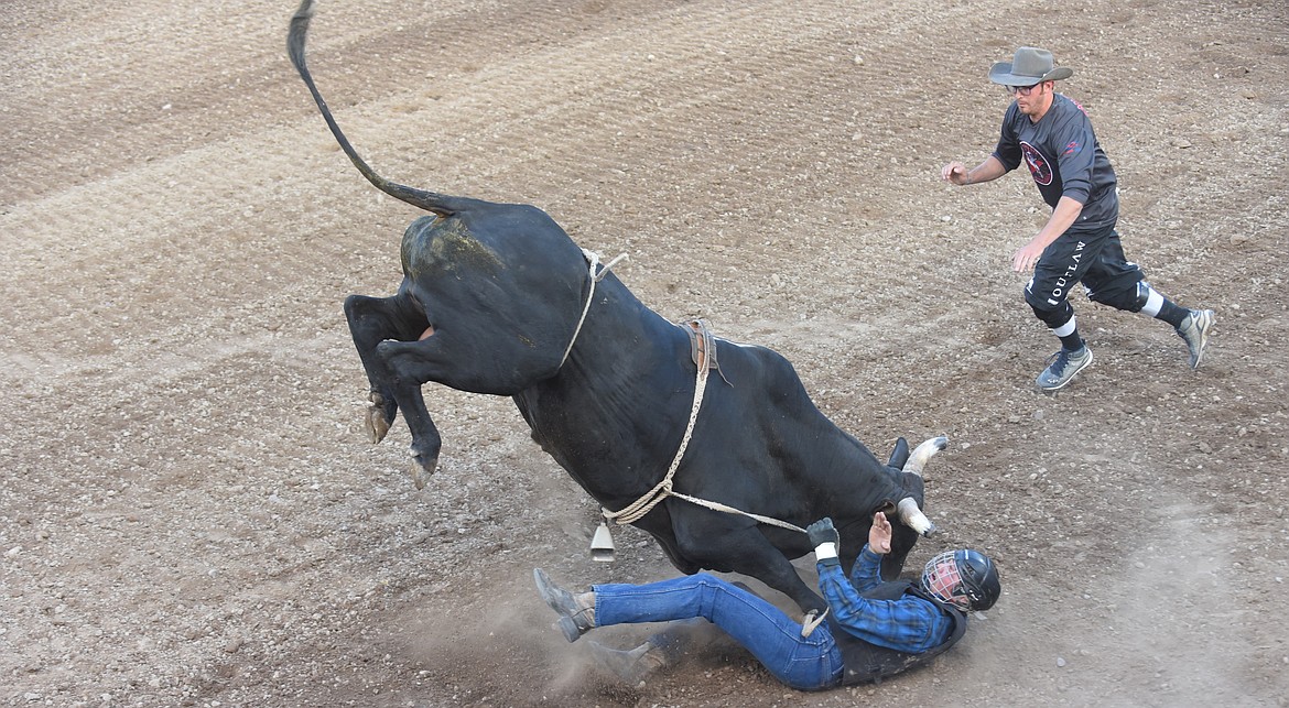 Plains’ Austin Stafford tangled with a bull during Thursday night’s event at the Sanders County Fair. (Scott Shindledecker/Valley Press)