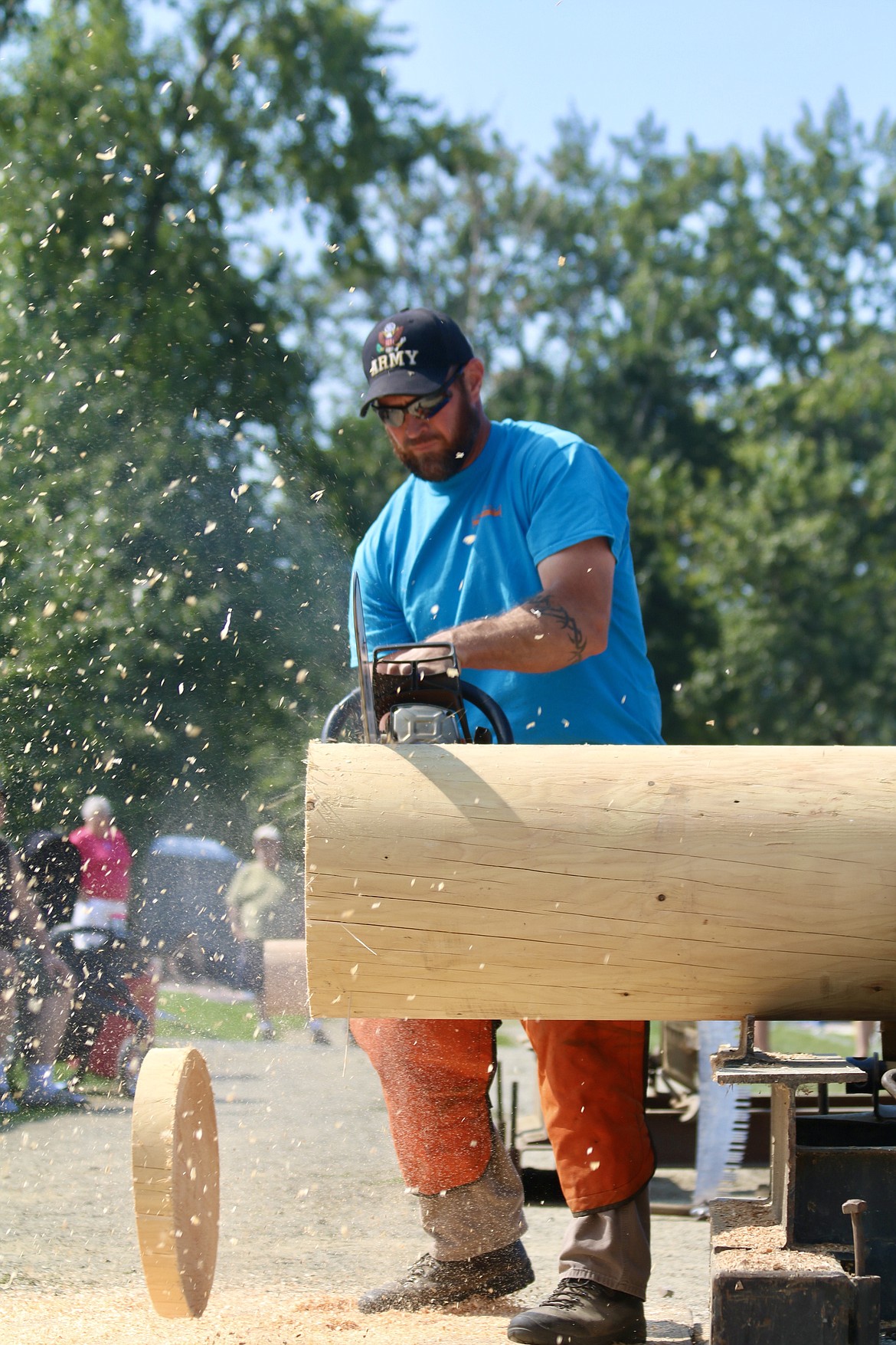 Paul Sotin, now an eight-time Logger of the Year, drops his first wood cutting and moves to the second in the men's power saw portion of the Paul Bunyan Days logging competition at St. Maries City Park on Sunday. HANNAH NEFF/Press