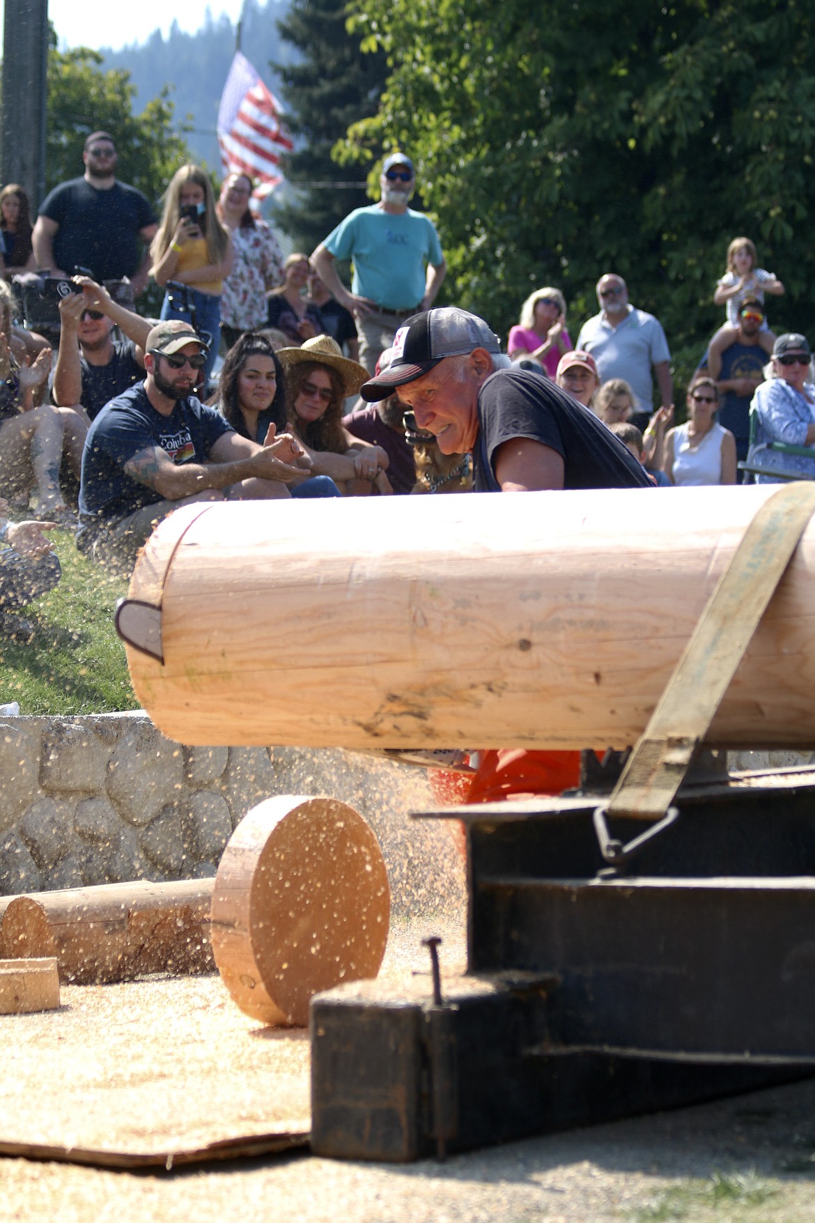 Earl Holdersen of Holdersen Logging, the oldest competitor, won the the men's power saw contest with a time of 19.2 seconds, five seconds faster than the second place participant, at the Paul Bunyan Days logging competition at St. Maries City Park on Sunday. HANNAH NEFF/Press