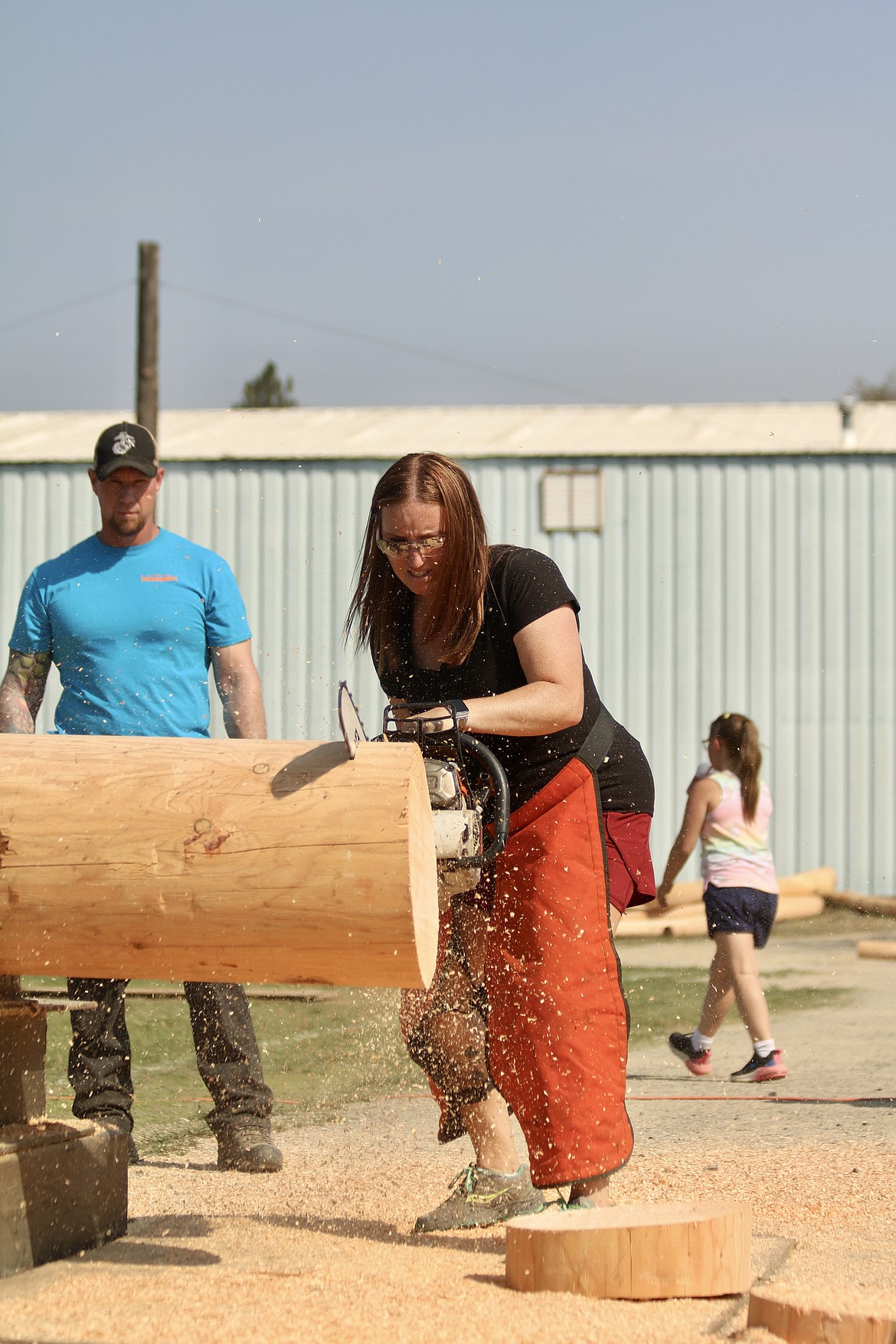 Suzzane Sotin, seventh-time winner of Logette of the Year, works her way through the women's power saw competition at the Paul Bunyan Days logging competition at St. Maries City Park on Sunday. HANNAH NEFF/Press