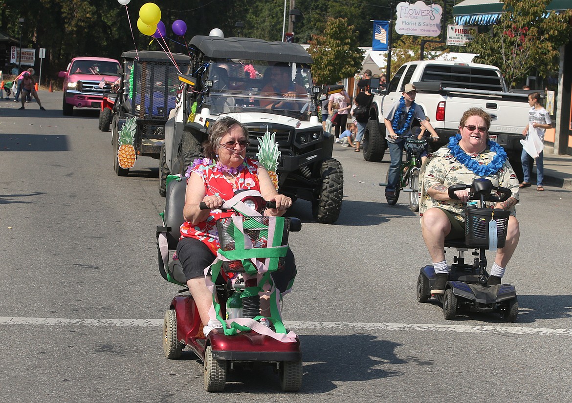 Janice John, left, cruises on Maine Street in the Spirit Lake Labor Day parade on Sunday.