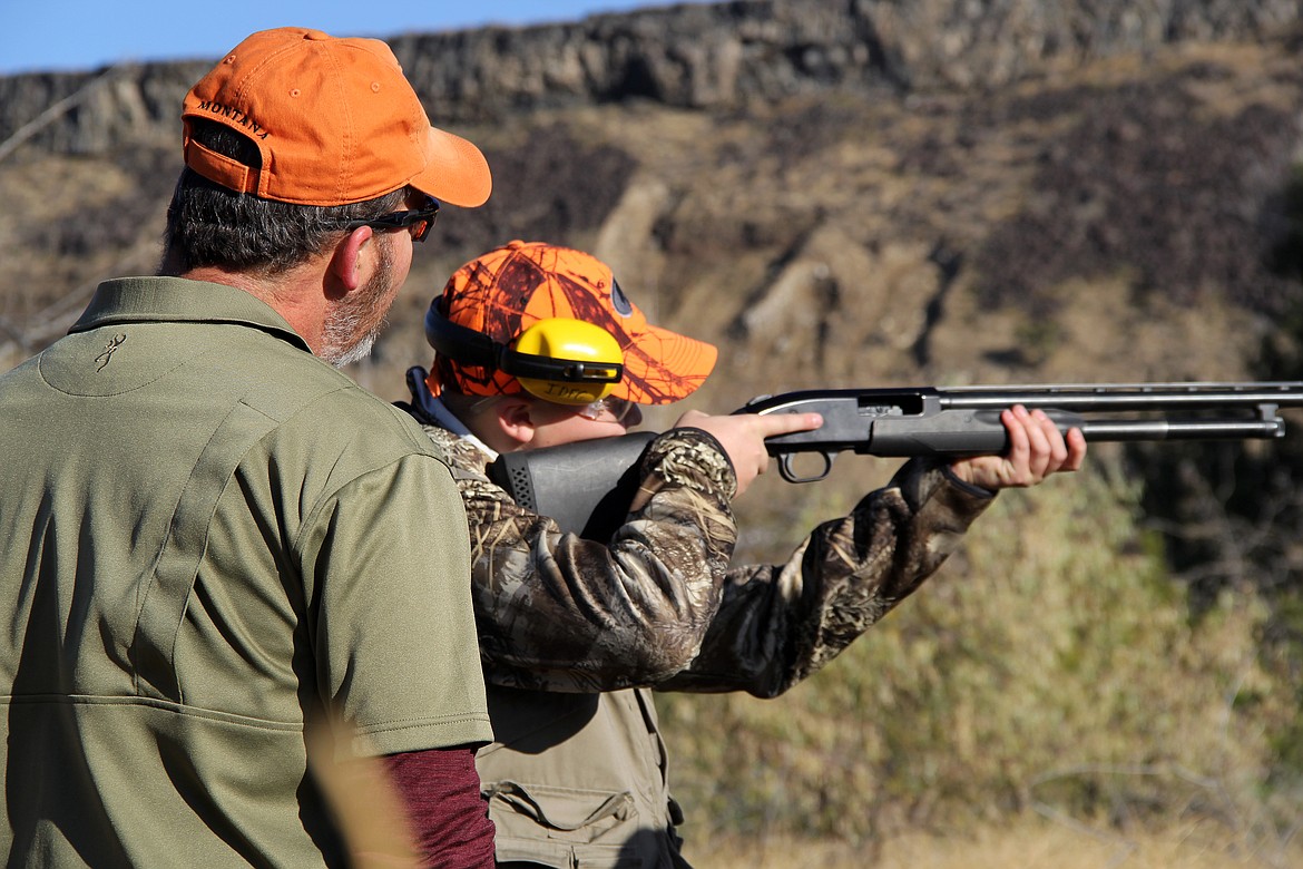 A youth attending the mentored youth pheasant clinic receives training in safe gun handling at the Niagara Springs Wildlife Management Area.