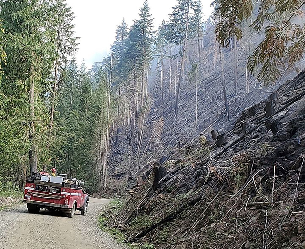 Engine crews mop up along the road in steep conditions on the Prater Red 2 Fire, located 11 miles northeast of Priest River.