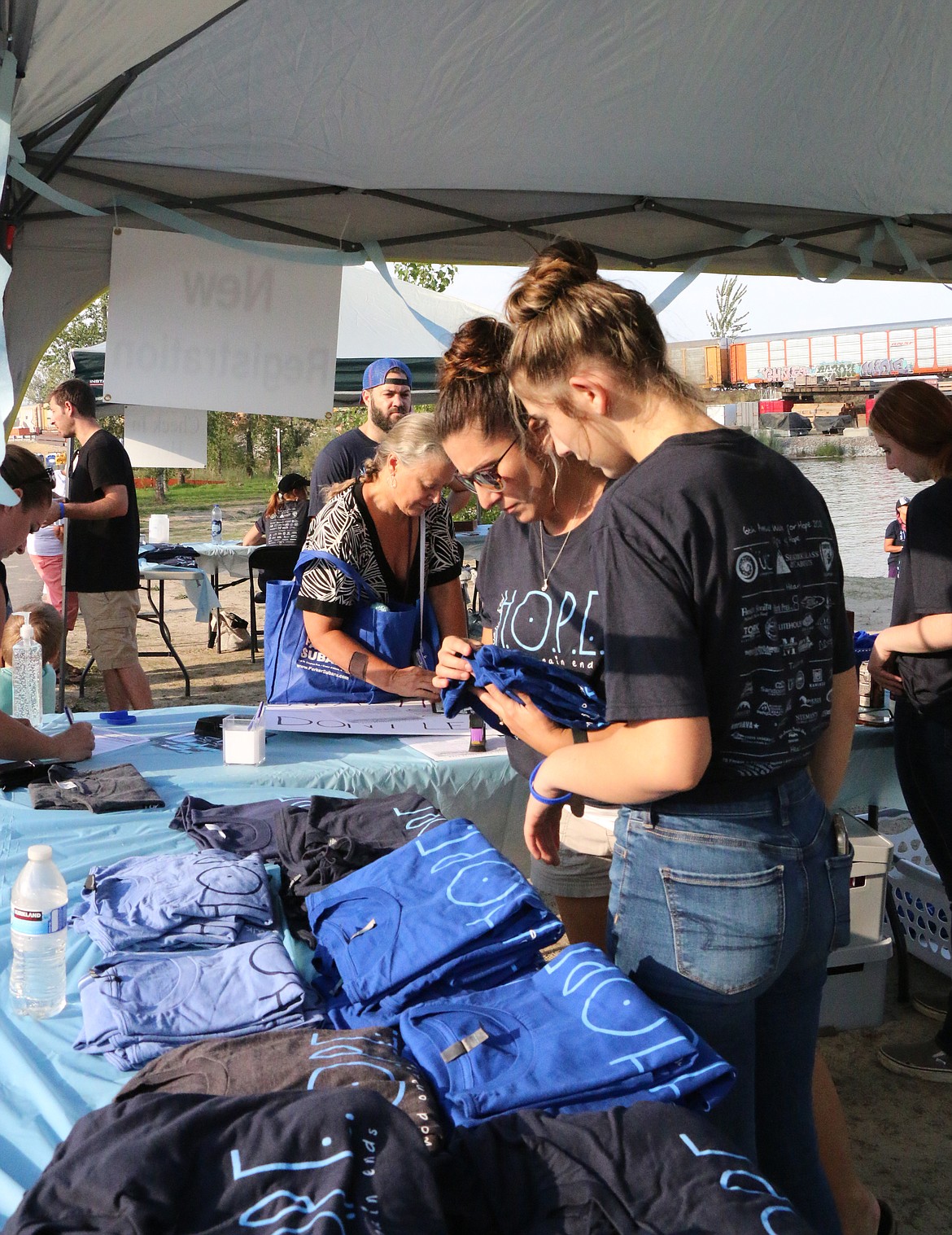 Jennifer Wyman, center, and a young volunteer help at the registration table at Sunday's Walk for HOPE.