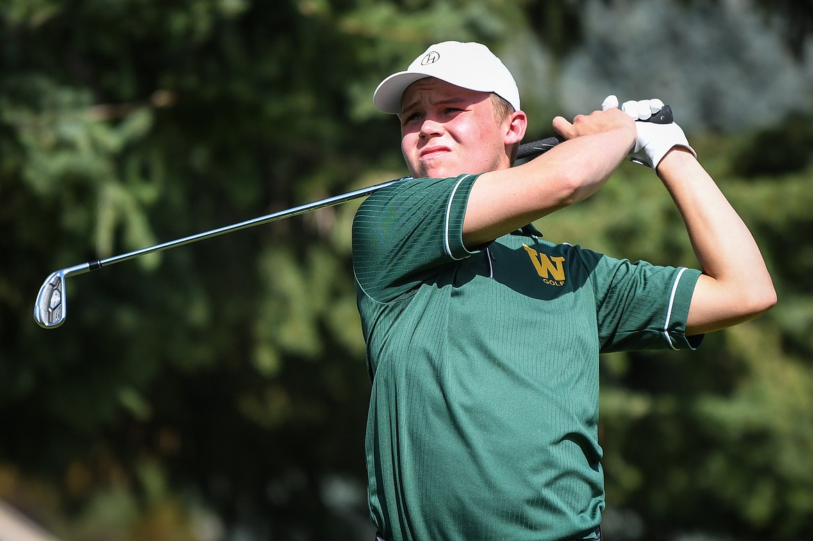 Whitefish's Johnny Nix watches his tee shot on the fifth hole of the South Course during the Whitefish Triangular at Whitefish Lake Golf Club on Tuesday, Sept. 7. (Casey Kreider/Daily Inter Lake)