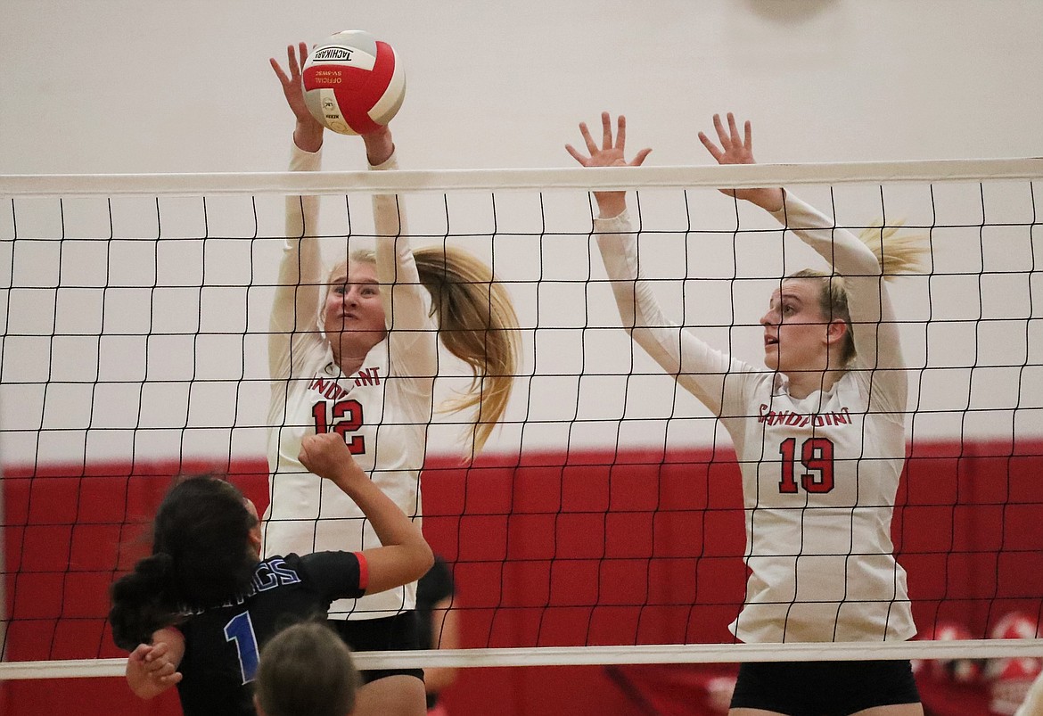 Vivian Platte (left) and Tori Pelkey elevate for a block on Tuesday.