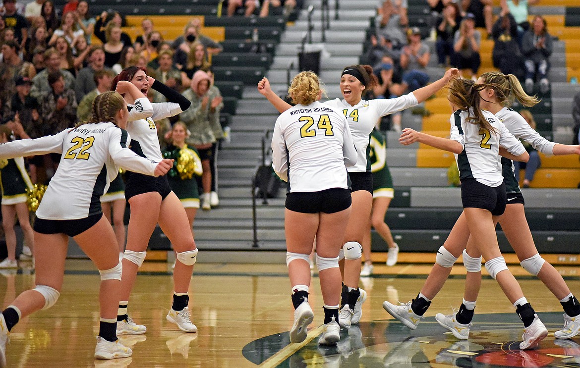 The Lady Bulldog volleyball team celebrates winning a point in a match against Frenchtown in Whitefish on Thursday. (Whitney England/Whitefish Pilot)