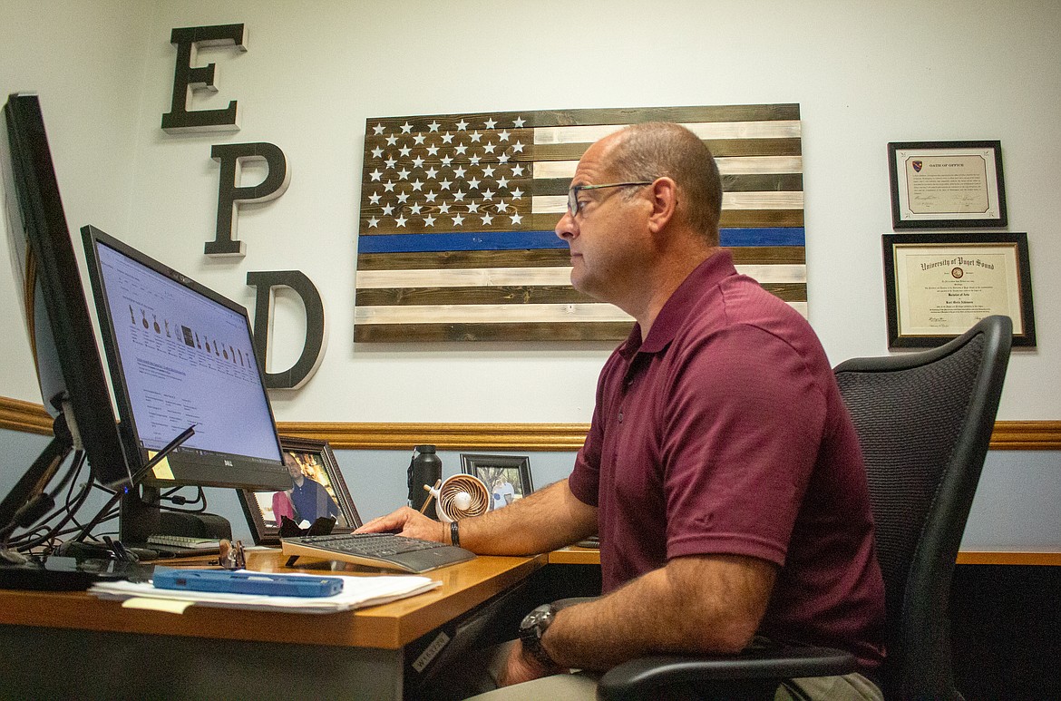 Ephrata Police Department Chief Kurt Adkinson works at his desk in his office in Ephrata on Tuesday.