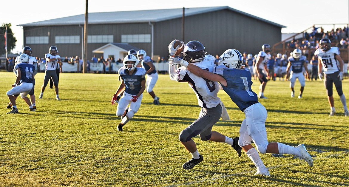 Charlo's Braydon Zempel (8) makes a catch in front of Mission defender Bryce Umphrey (1). (Scot Heisel/Lake County Leader)