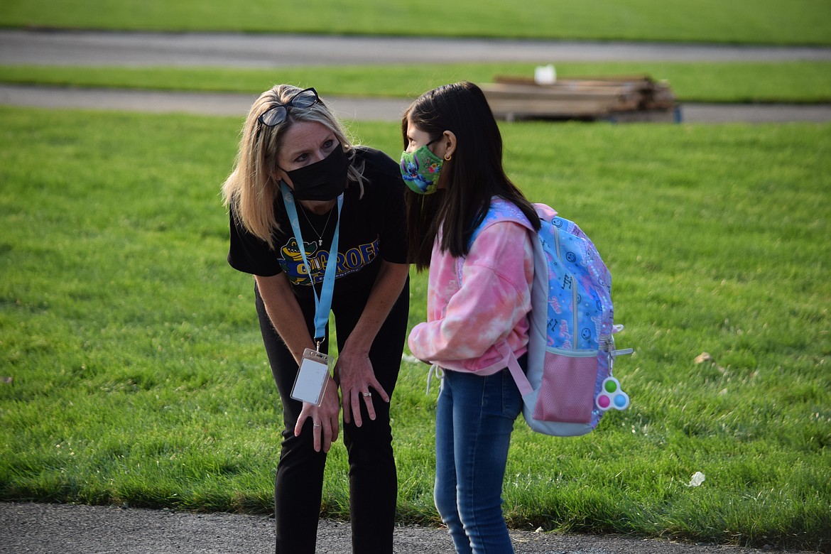 Groff Elementary School Principal Nikki Mackey helps a student figure out where to go Tuesday.
