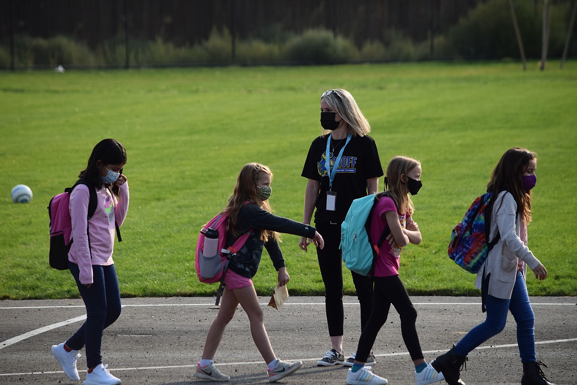 Groff Elementary School Principal Nikki Mackey watches students walk to class after assembling in the playground at the grand opening of Moses Lake School District’s newest elementary school.