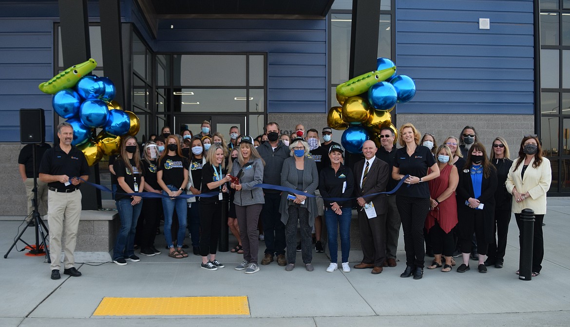 Groff Elementary School Principal Nikki Mackey and Moses Lake School Board President Vickey Melcher, surrounded by Groff teachers, school board members, Moses Lake School District administrators and members of the Moses Lake Chamber of Commerce, cut the ribbon during a formal ceremony Tuesday morning to celebrate the opening of Groff, the district’s newest elementary school.