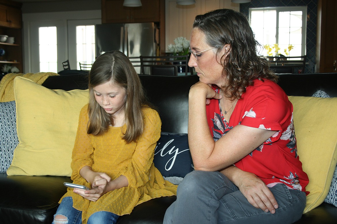 Kristi Jenks (left) and her mom Heather Jenks (right) review their portfolio of dog park ideas.