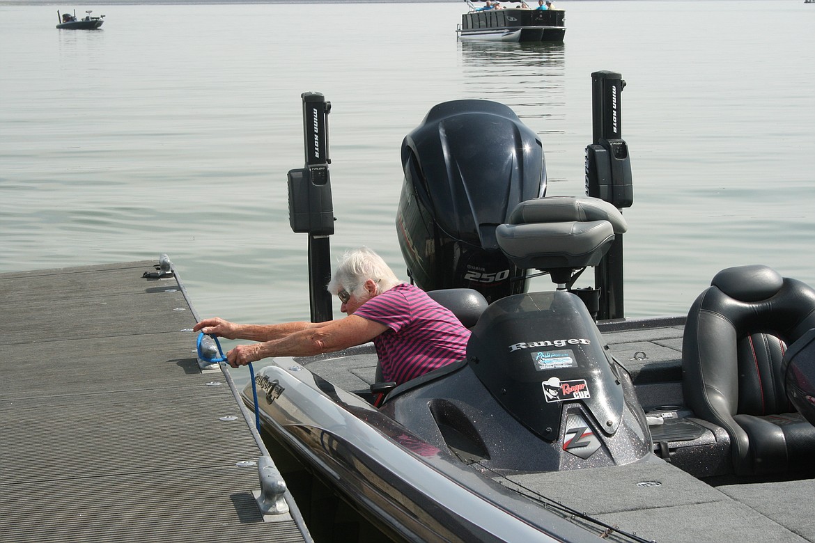 Siena Abbey ties up a boat Saturday at Potholes Reservoir.