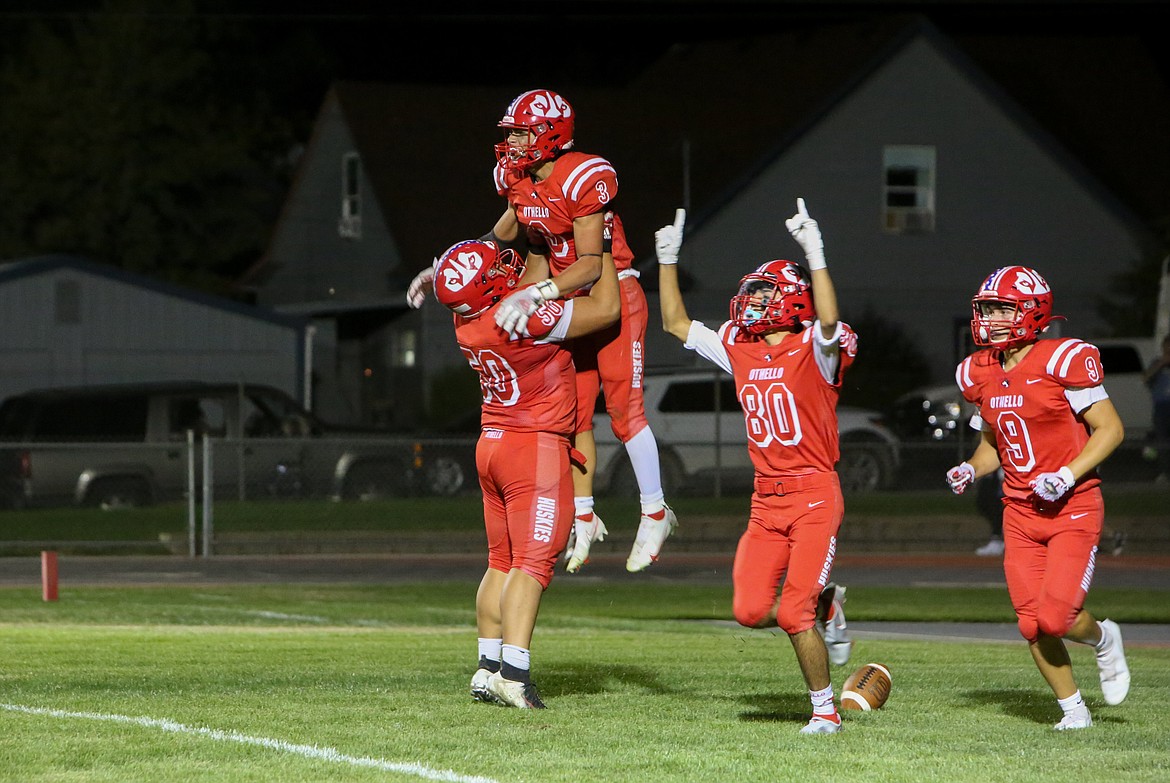 Othello’s Mason Perez, No. 50, lifts teammate Ezra Gonzalez, No. 3, into the air after Gonzalez scored the winning touchdown in the fourth quarter against Connell Friday.