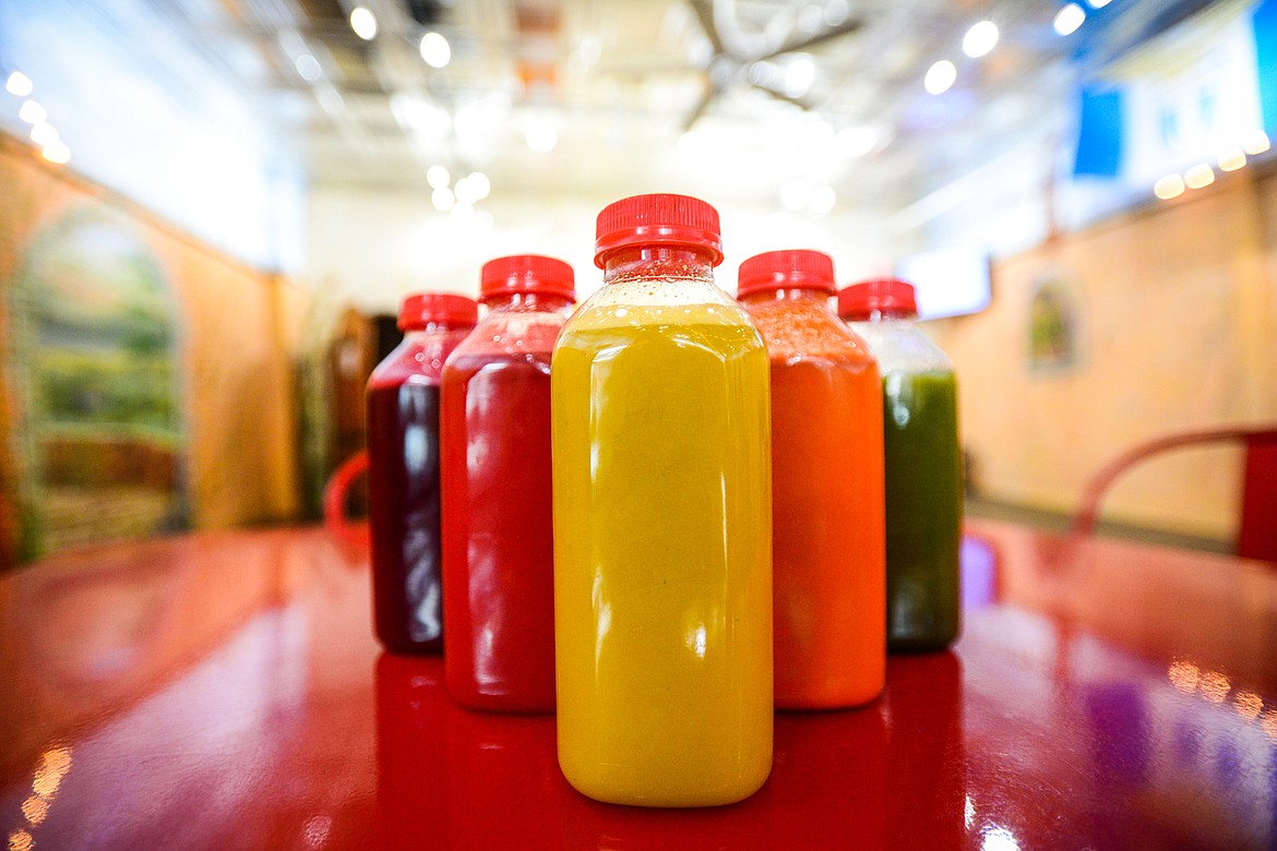 A variety of organic juices, from left, Bitter Roots, Watermelon Cooler, Organic Orange Juice, Turmeric Dream and Mean Green at Huck's Place Ginger Brew and Juice Bar in Whitefish on Wednesday, Sept. 8. (Casey Kreider/Daily Inter Lake)